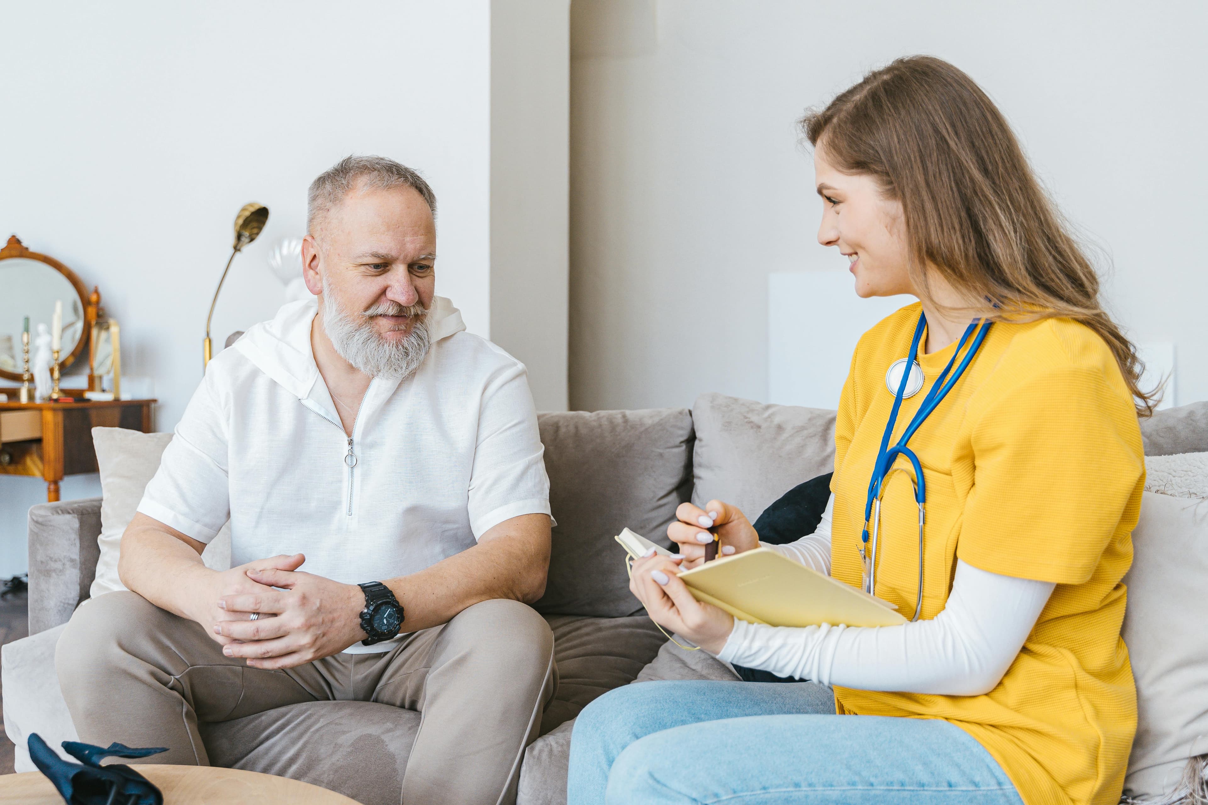 Caregiver assisting elderly clients with activities